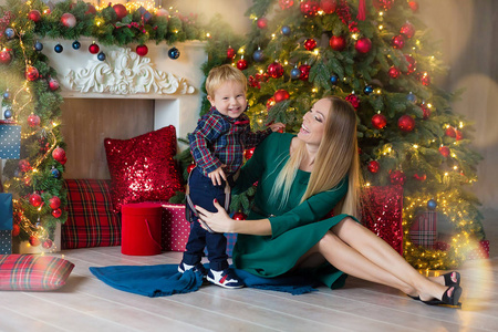 s holidays. Toddler with mom in the festively decorated room wit