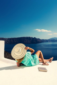 豪华旅行度假女性，看希腊圣托里尼岛的风景。令人惊叹的海景和卡尔德拉。