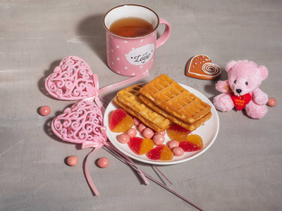 s Day. Pink dishes, decor and Viennese waffles with a mug of tea