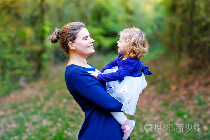 愉快的年轻母亲有乐趣可爱的幼儿女儿家庭肖像在一起妇女与美丽的女婴