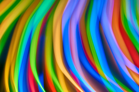 模糊的彩色Bokeh抽象在未聚焦的背景颜色Bokeh背景和纹理色条线与长曝光和运动灯。
