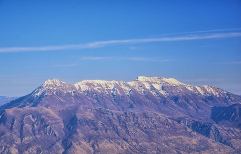 冬季飞越科罗拉多和犹他州的瓦萨奇前线落基山景观的空中景观。大盐湖犹他州普罗沃蒂姆帕诺戈斯孤峰和双峰山和景观格局附近的宏伟