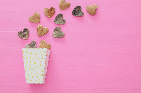 s day concept. wooden hearts over pink background. Flat lay