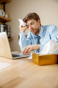 病人带着手帕打喷嚏，在办公室工作时，商人患了季节性感冒。 预防流感大流行办公室空调引起疾病