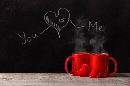 s day concept with red mugs, chalk inscription and red felt hear