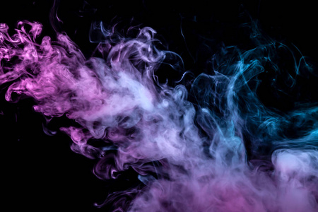 蓝色和粉红色的彩色烟雾在黑色孤立的背景上的俱乐部，以软云的形式从蒸气中消失