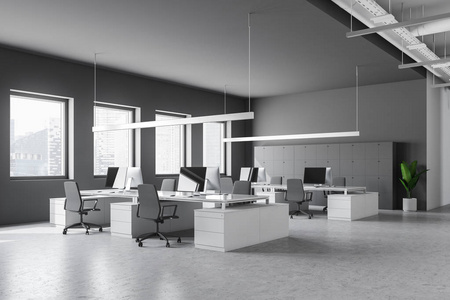 时尚办公室的角落，白色和灰色的墙壁，石头地板，白色的电脑桌，灰色的椅子和储物柜靠近墙壁。 3D渲染