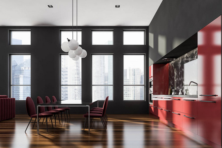 侧景现代厨房与黑色和黑色大理石墙壁，木地板，红色台面，两个炉子和黑色桌子与椅子。 3D渲染