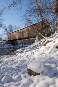 s historical red covered bridge on a snowy sub zero winters day.