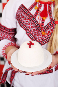 传统的凝乳复活节甜点与蔓越莓，乌克兰，俄罗斯风格，有彩色鸡蛋在盘子里的女性手