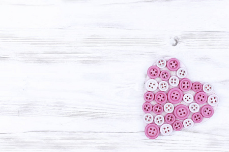 s Day. pink heart on white boards background