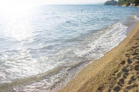 蓝色的海水波浪和带树的沙滩。