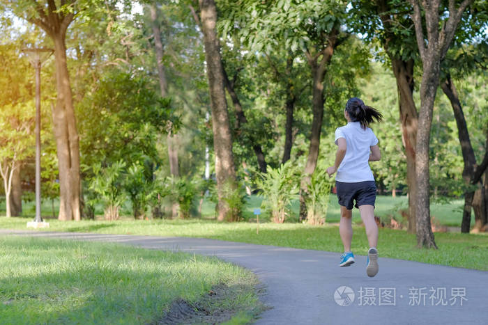 年轻的健身妇女在公园跑步,户外女跑步者在亚洲运动员