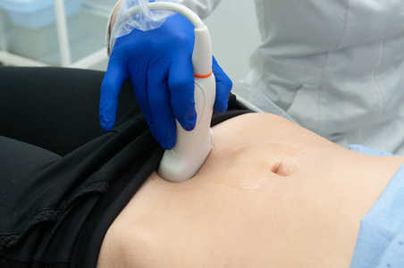 s hand moves ultrasound sensor on pregnant woman39