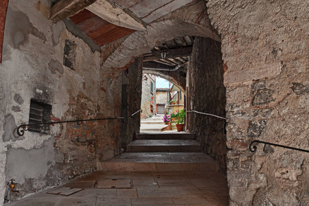 Orcia, Siena, Tuscany, Italy picturesque alley with underpass i