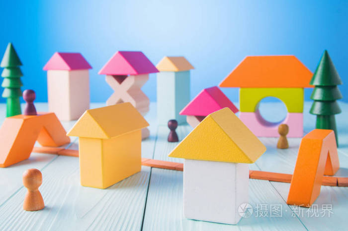 玩具木屋从彩色积木在蓝色背景 建筑建设理念.