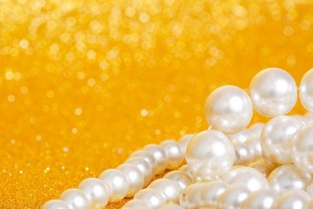 金色圣诞背景上的一堆珍珠