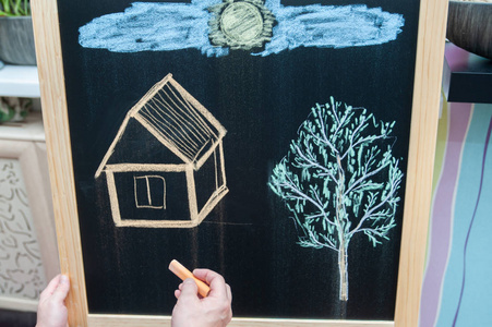 s drawing, a house and a tree, the concept of creativity with co