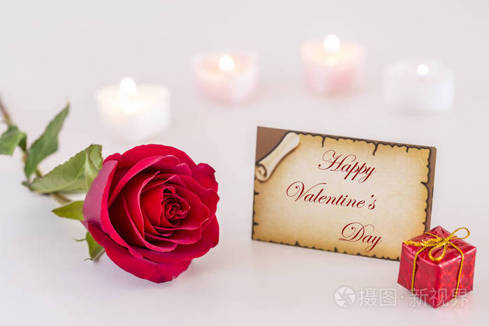 s day text, single red rose, gift box, and candle light on white