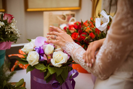 新娘站在室内，手牵着鲜花