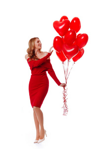 迷人的年轻女孩在红色礼服举行情人节氦气球