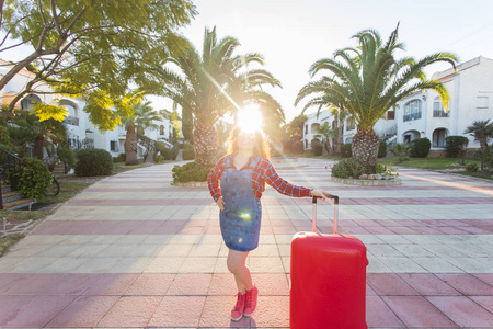 旅行旅游和人的概念快乐的年轻女子带着红色的行李箱和微笑一起旅行