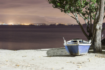 s boat chained to a tree at the beach. Paqueta Island, Brazil. R