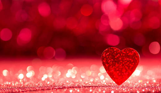 s day. A bright red heart on a shining red background with bokeh