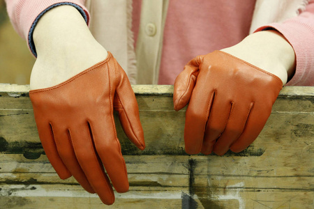 s hands wearing brown reddish vintage gloves.Elegance and fancy 