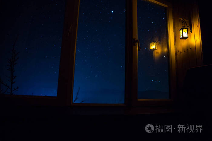 从黑暗的房间透过窗户看到星星的夜景.