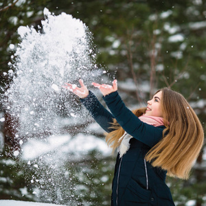 可爱的少女在一个令人惊奇的冬天玩雪。