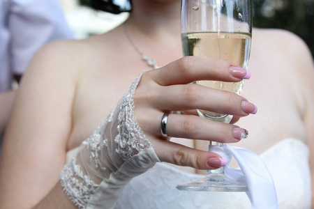 s hand with a glass of champagne