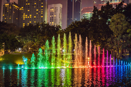 晚上, 湖上的五颜六色的喷泉, 靠近双子塔, 背景是城市。吉隆坡, 马来西亚