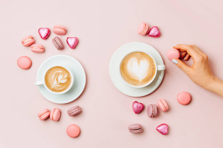 s hands  holding cup of coffee on pale pink background.   Flat l