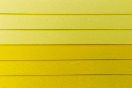 木材黄色背景。黄色合成木墙纹理用于背景。彩色木板涂上黄色。 木材背景