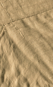 麻布网格纹理背景。 浅棕色的布料。 轻盈的天然亚麻纹理。 棕色帆布背景纹理