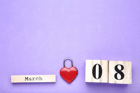 s Day on wooden calendar with heart shaped padlock on purple bac