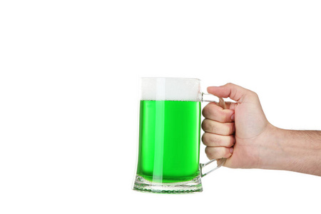 s Day. Glass mug with green beer in male hand on white backgroun