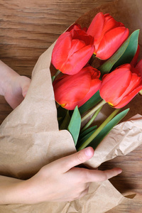 s day girl child congratulates gives a bouquet of flowers tulip