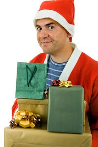 持有一些礼物，孤立的圣诞老人帽的年轻人