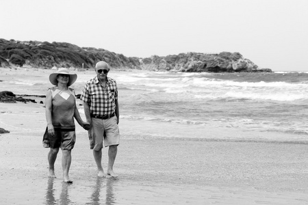 快乐老年夫妇享受他们的退休度假，在海边