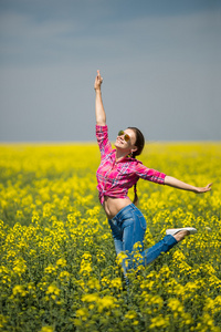 年轻漂亮的女人在夏天开花领域。户外活动