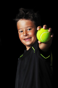 英俊的男孩，与网球的肖像