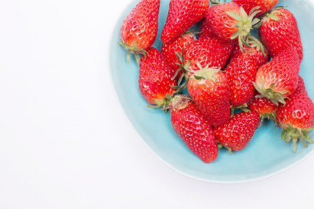 在白色背景上孤立的碗中的新鲜草莓