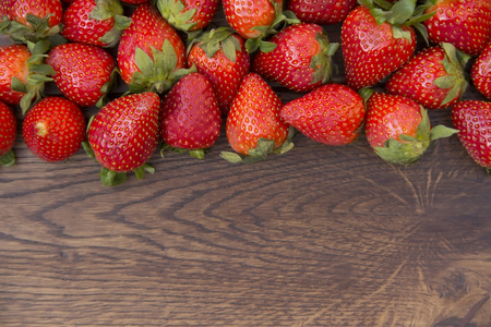 草莓铺在棕色木质的表面上