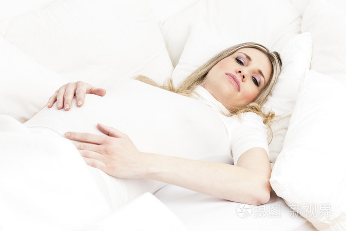 怀孕的女人在床上休息