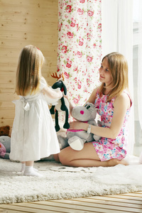 漂亮金发小女孩和她妈妈玩软玩具 nea