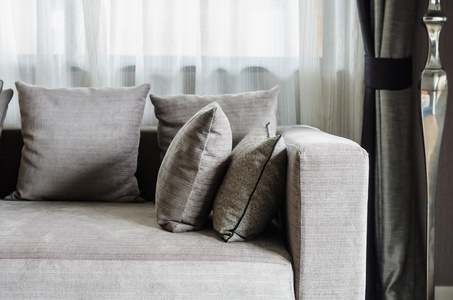 现代客厅里的沙发上的灰色枕头