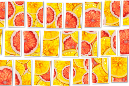 粉红葡萄柚和橘子混合五颜六色的切片的水果拼贴