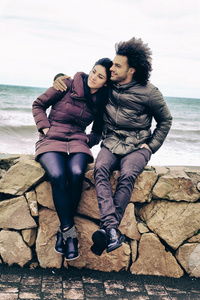幸福的酷夫妇站在冬天海洋